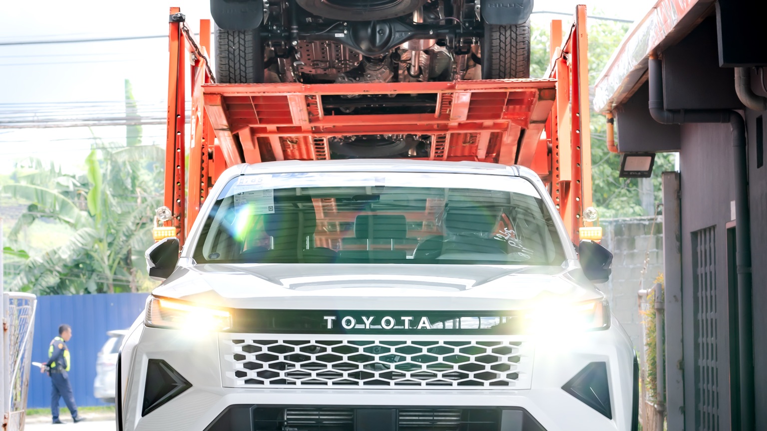 A brand-new Toyota Hilux driven onto a transport carrier